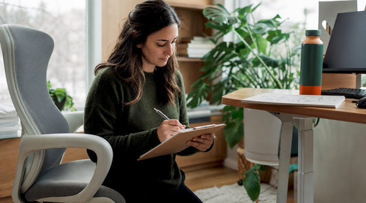 Therapist evaluating ergonomic chair setup in clinic