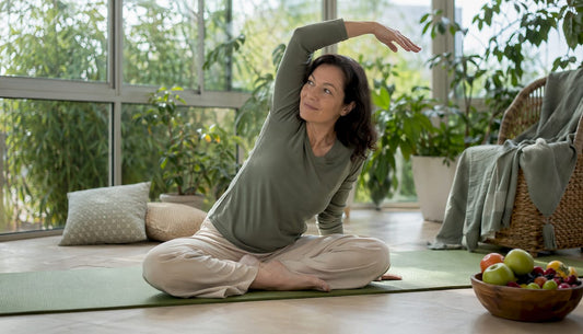 Woman stretching in living room for back pain relief