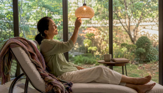 Woman adjusting warm mood lighting at home