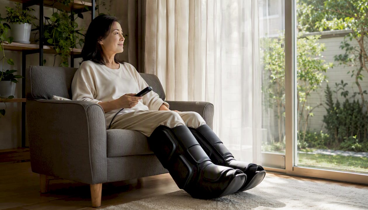 Woman using leg massager at home