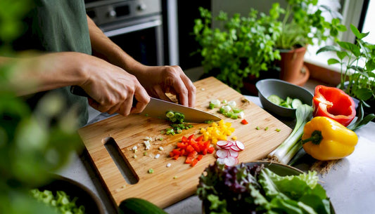 Hands chopping vegetables in kitchen