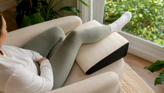 Contoured wedge pillow supporting elevated knee