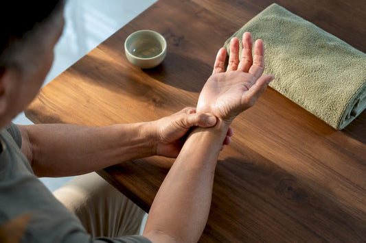 Adult performing targeted wrist massage