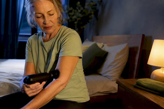 Woman using massage gun before bedtime