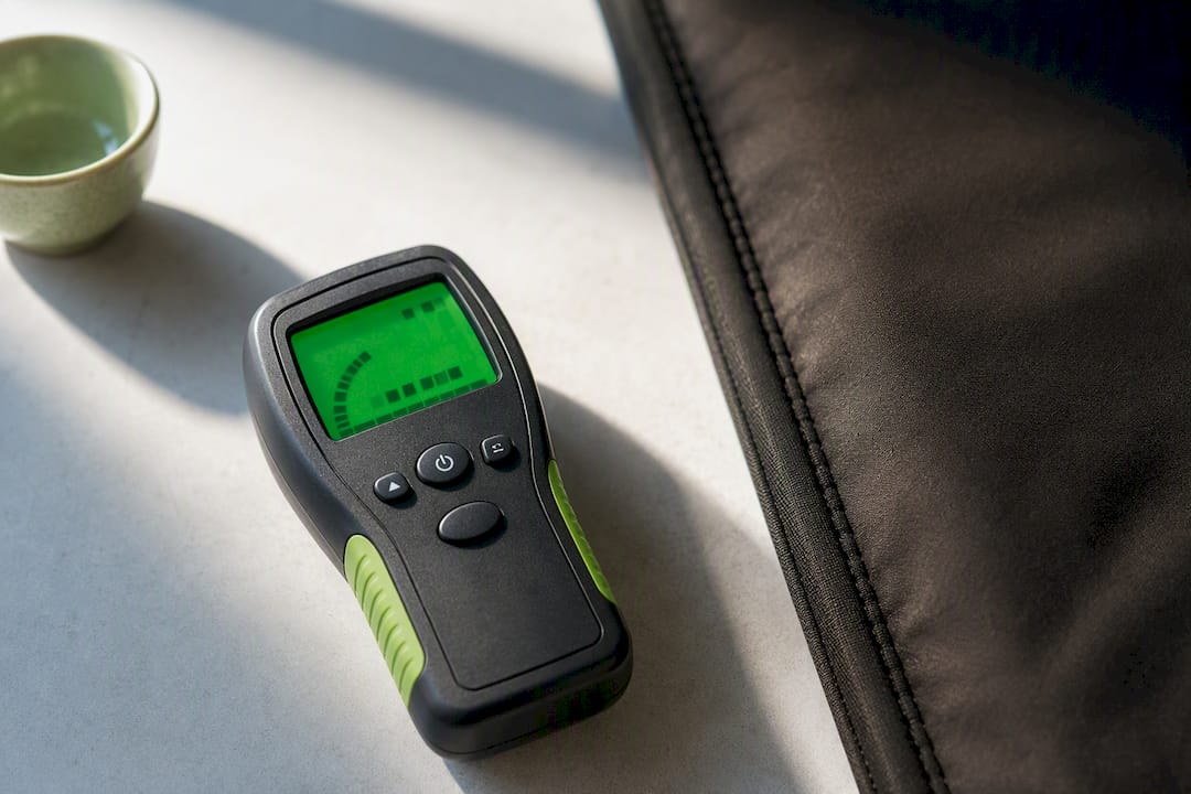 EMF meter beside heated wellness textile