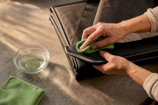Hands cleaning a sauna blanket textile edge