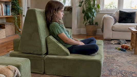 Child seated on supportive modular play couch