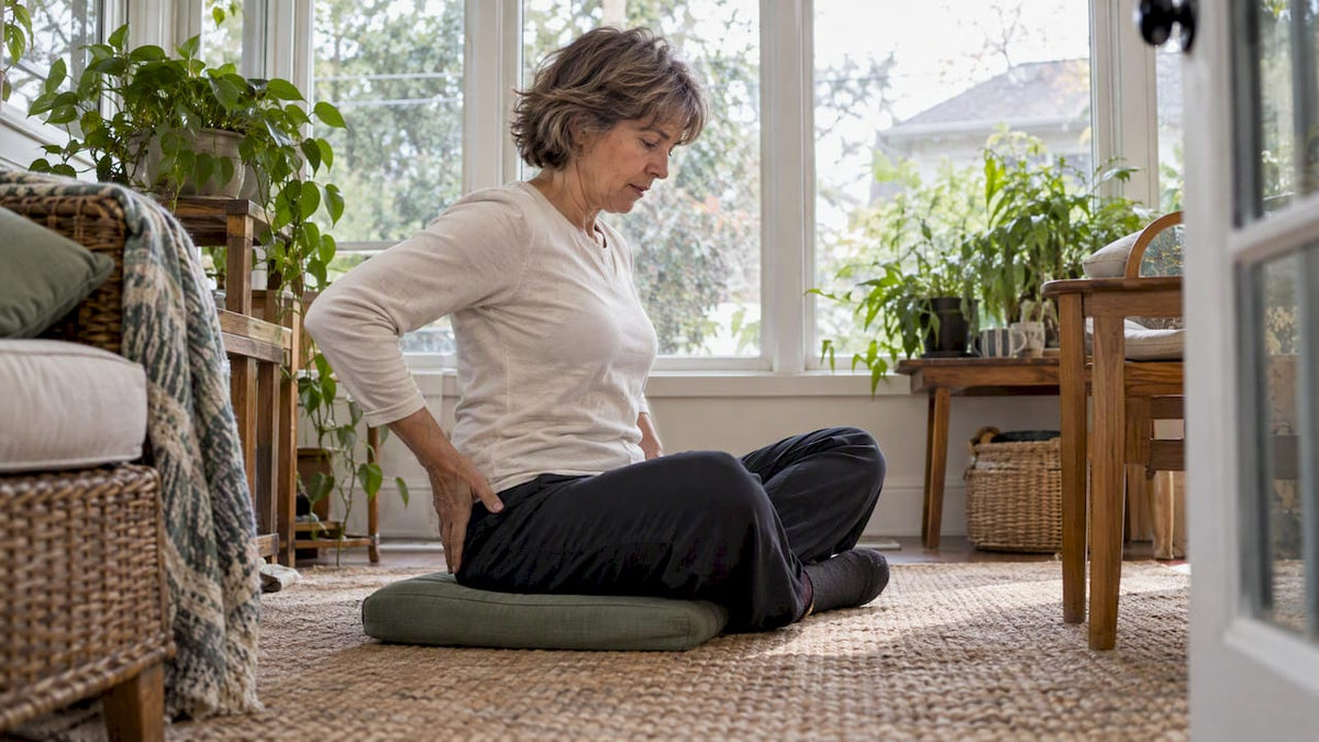 Woman floor sitting on a thin cushion