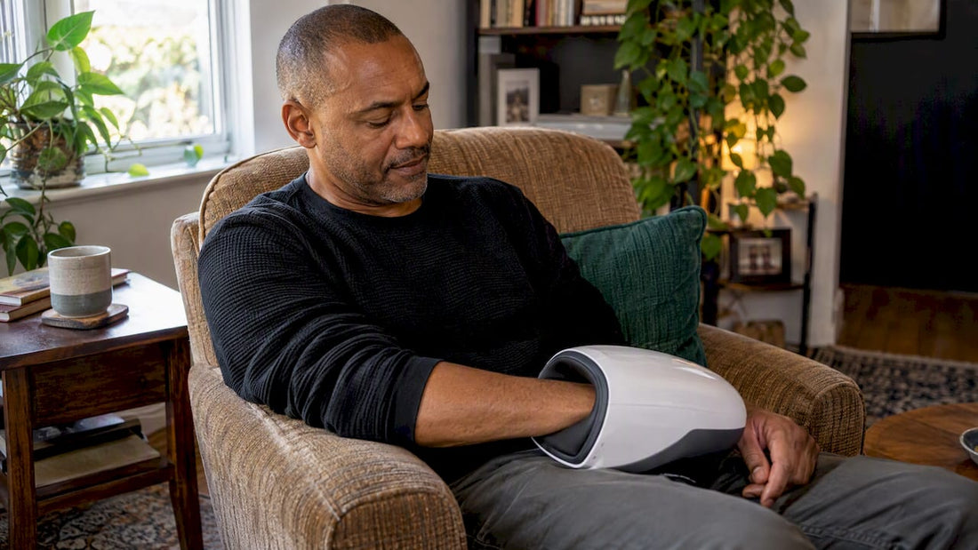 Man resting hand in a hand massager