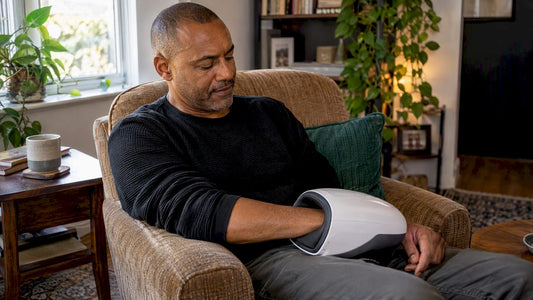 Man resting hand in a hand massager