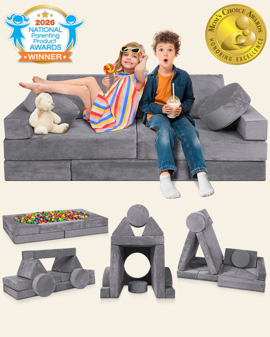 Gray modular foam play couch with children sitting on it.
