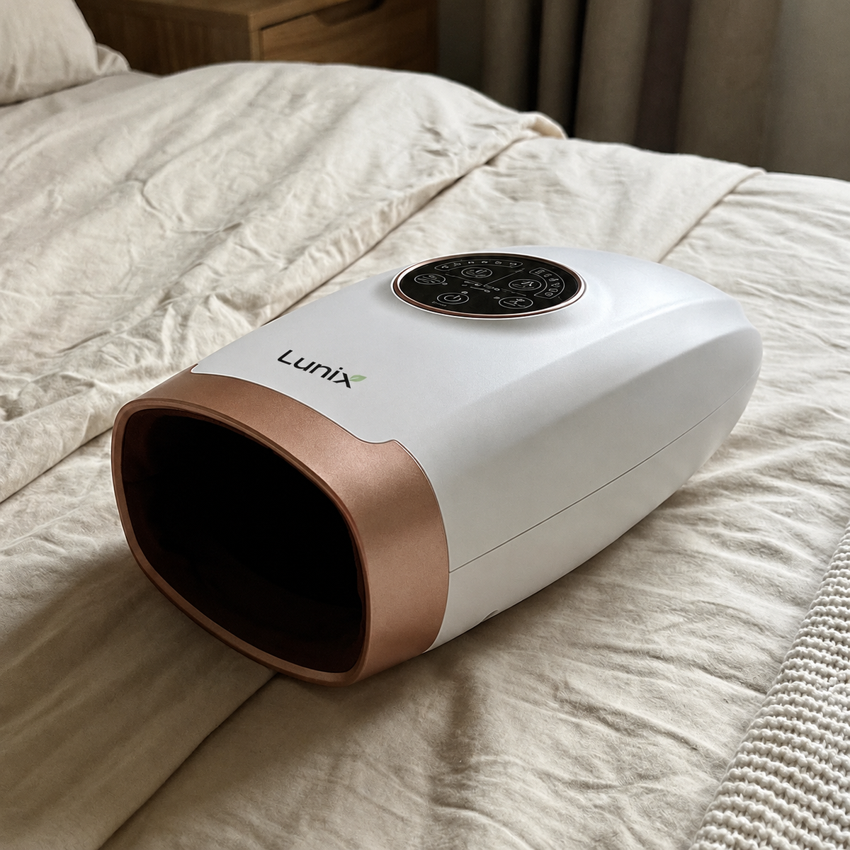 Lunix Hand Massager on to of a bed.