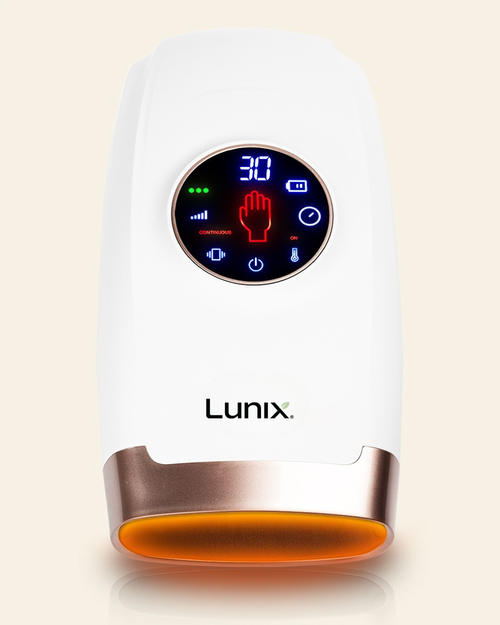 A white Lunix hand massager with a circular digital display showing blue and red interface icons, set against a light beige background.