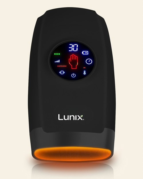 A black Lunix hand massager with a circular digital display showing blue and red interface icons, set against a light beige background.