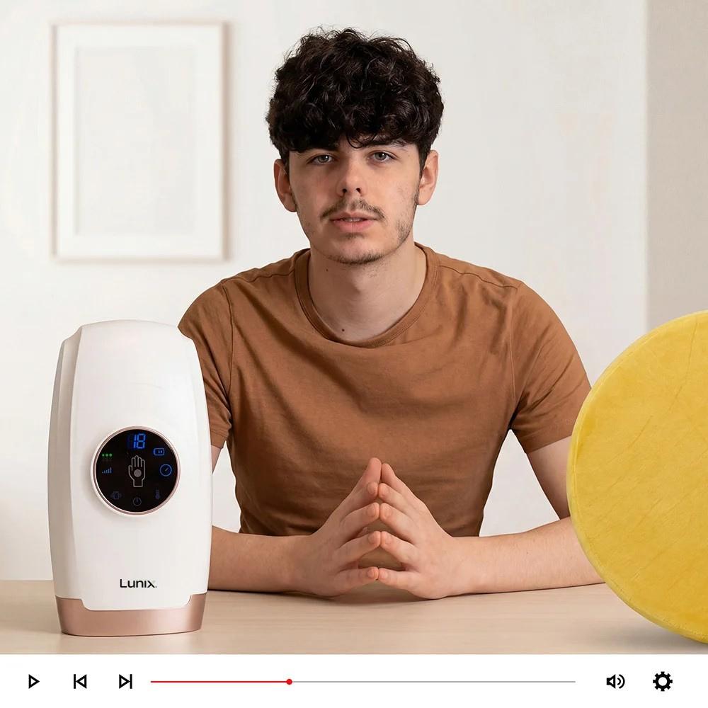 Man sitting at a table with a white hand massager next to him